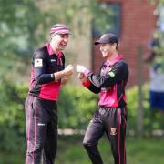 All smiles - Colchester and East Essex captain Darren Eckford (left) celebrates a wicket with team-mate Julian Russell against Billericay Picture: TRACY HILLS