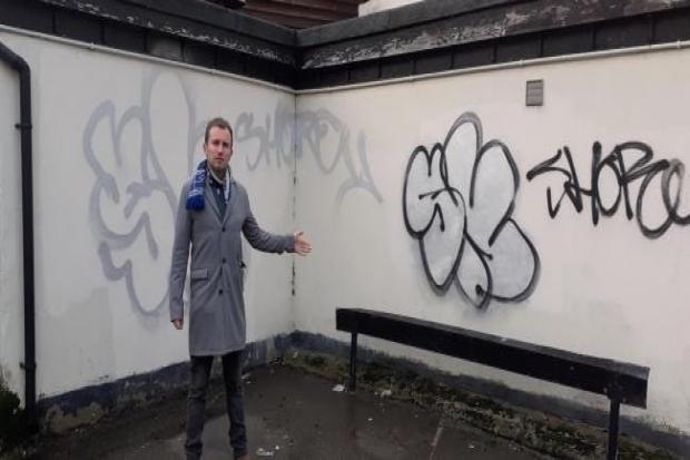 Councillor Lee Scordis with some graffiti in Colchester